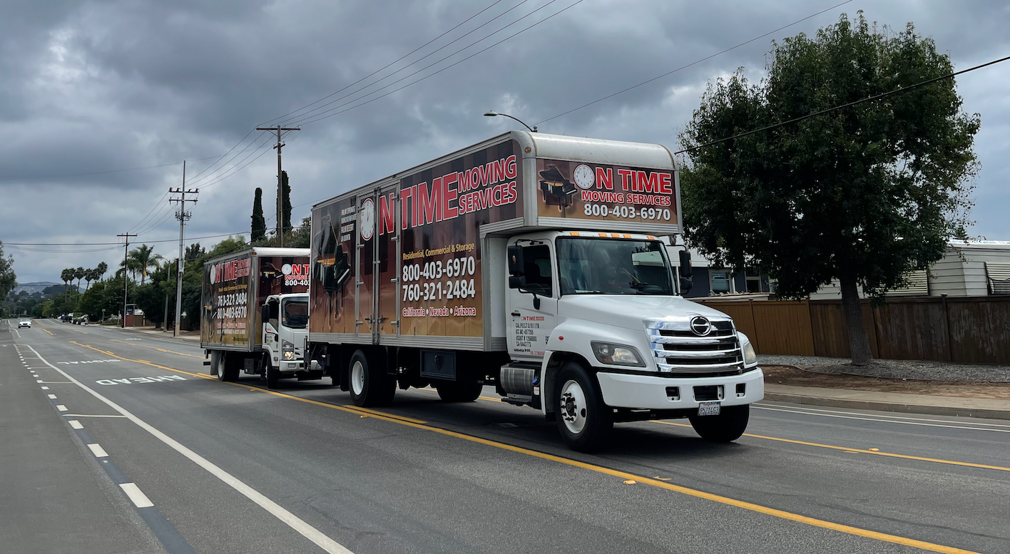 On Time Moving Services truck parked on a residential street lined with palm trees