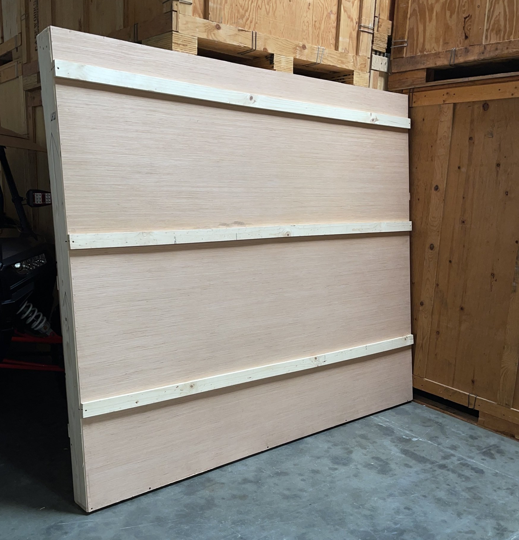 Large wooden shipping crate standing in a warehouse