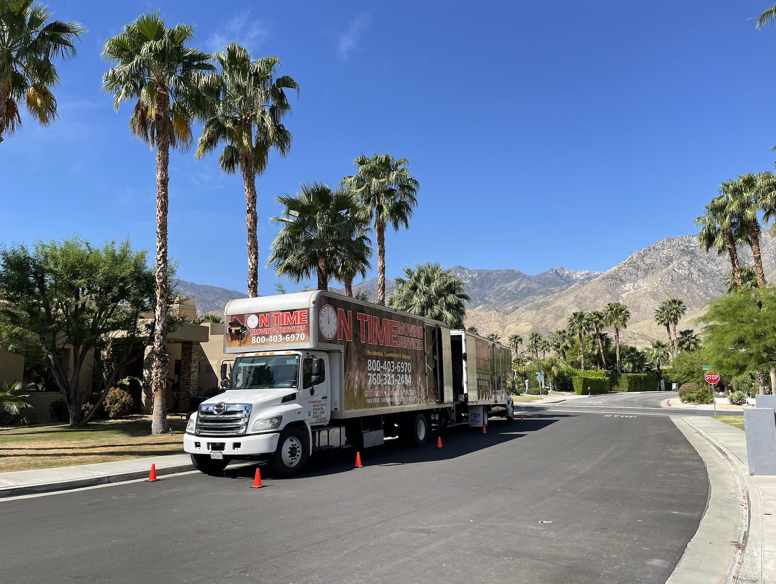 On Time Moving Services truck parked at a luxury estate at golden hour